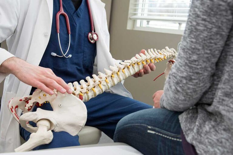 A chiropractor gently assessing a person's posture in a bright, comfortable clinical setting.